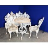 A set of seven white painted cast iron Garden Chairs and a Table (2ft diam.), with pierced and