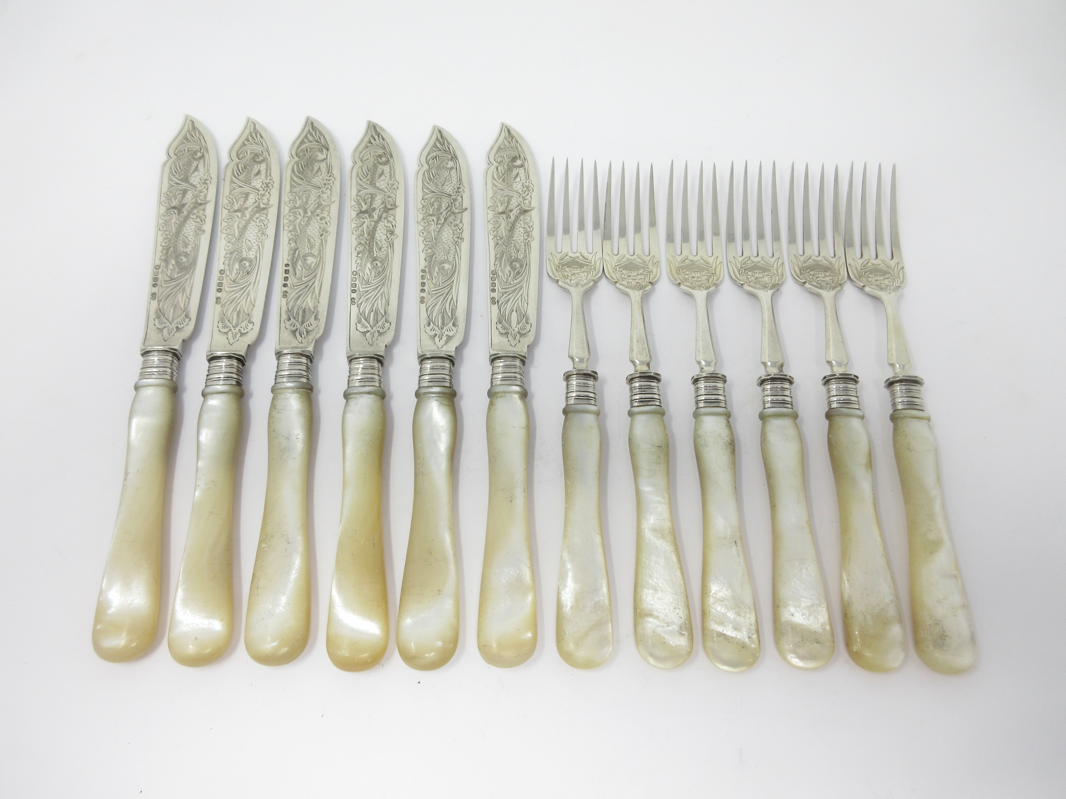 Six Victorian Fish Knives and Forks with finely engraved silver blades and mother-of-pearl hafts,
