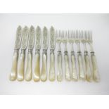 Six Victorian Fish Knives and Forks with finely engraved silver blades and mother-of-pearl hafts,