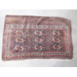 A Turcoman Yomut Chuval with three rows of three guls in brick red, brown and blue, etc, 2ft 2in and