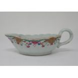 A Chinese famille rose Sauceboat painted flowers in coloured enamels 7 1/2in, hairline crack