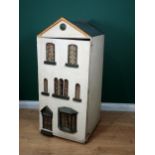 A mid to late 19th Century Doll's House having three storeys, hinged front, glazed windows and conta