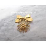 A Victorian Seed Pearl Star Brooch stamped 15ct suspended from later 9ct gold bow brooch. Diameter o