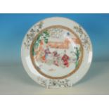 A Chinese famille rose Plate, decorated figures and child at a table, 9in diameter