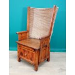 A late 19th or early 20th Century pine Orkney Chair with traditional woven back, scroll ends to arm