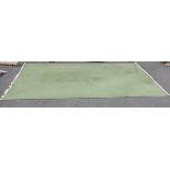 A large green ground Carpet with tasseled fringe, 19ft 4in x 11ft 3in