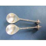 A pair of Danish silver Spoons with ornate mask and scroll finials, leafage stems and scrolls to rev