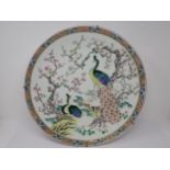 An Oriental Charger decorated exotic birds amongst flowering trees, 16in diameter, hairline crack