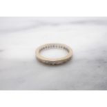 A Diamond Eternity Ring channel-set baguettes, ring size O 1/2, stones deficient