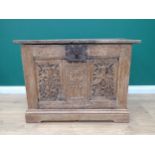 An antique oak Chest utilising 16th Century panels with pin hinged plank lid above front with pair