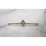 A Bar Brooch millegrain-set step-cut blue synthetic stone, stamped 9ct