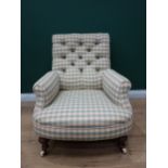 A 19th Century Armchair with chequered button upholstery on turned front supports and casters (one c