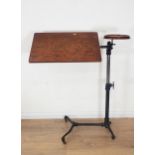 A Victorian cast iron and oak Reading Stand by Foot & Sons with adjustable height and rotating surfa