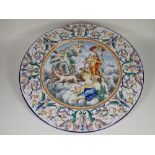 A large pair of Italian Majolica Chargers, central panels of allegorical figures, on chariot, angels