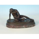 A bronze seated Figure of a naked gladiator with a wound to his chest, on an oval marble base, 6 1/2