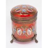 A red glass Box and Cover with gilt metal mounts and cylindrical form having hinged cover and painte