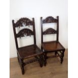 Two 17th Century and later oak Derbyshire Chairs both with mask and scroll carved double back rails