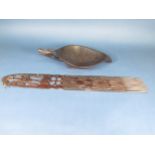 A hardwood Tribal Feeding Bowl with carved mask handle, 16in, and a large Comb with incised and pier