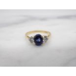 A Sapphire and Diamond three stone Ring claw-set oval-cut sapphire between two brilliant-cut diamond