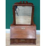 A George III mahogany Dressing Mirror with shaped surmount, the mirror above a sloping fall front en