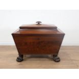 A late Regency mahogany Cellaret of sarcophagus shape with interior divisions, oval gadroon carved h