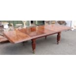 A Victorian extending Dining Table with pull out action, moulded top with two spare leaves all mount