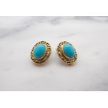 A pair of Turquoise ear Clips each set oval cabochon within pierced Greek key frame, stamped 585