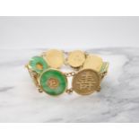 A Chinese Jade Bracelet having gold discs embossed characters, three of these mounted jade circles o