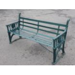 A Victorian green painted cast iron Garden Bench with slatted back and seat supported by perpendicul