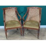 A pair of Regency mahogany Elbow Chairs with cane infilled backs, open scroll arms and green upholst