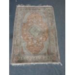 A bordered Persian Rug with shaped floral medallion on a rust ground, the main border with palmettes