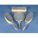 A Danish silver mounted four-piece Dressing Table Set, viz: Hand Mirror, pair of Hair Brushes and Cl