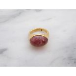 A 22ct gold Ring rubover-set oval pink cabochon, ring size K 1/2, approx 10gms all in