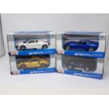 Four boxed Maisto Special Edition 1:24 scale models including Porsche 911, Audi R8, Jeep Wrangler