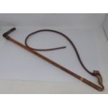 A Swaine & Co., London Hunting Whip with stag horn handle, silver brand button, ornate braided