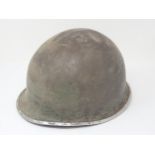 A WWII American Combat Helmet with liner (front seam), a Brown Bess Bayonet and an 1853 Enfield