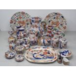 Seven stoneware Jugs of octagonal form decorated in Imari colours with serpent handles, 6½ to 3in,