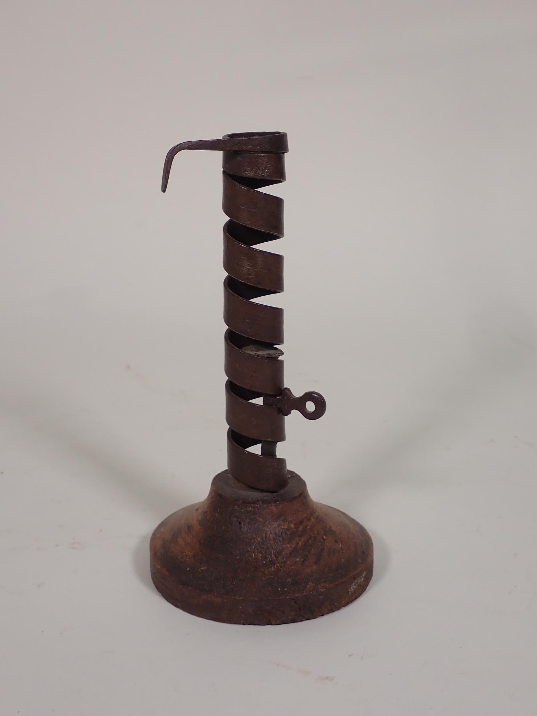 An iron spiral Candle Holder with rotating ejector on wooden base, 7½in H