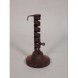 An iron spiral Candle Holder with rotating ejector on wooden base, 7½in H