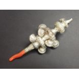 An antique style white metal Child's Rattle with coral mount, possibly Indian, 5in
