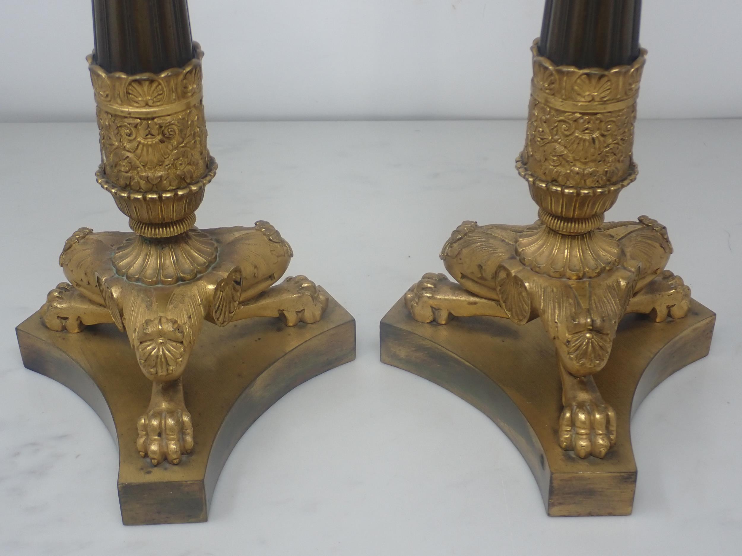 A pair of French Empire Candlesticks in ormolu and bronze, with classical mouldings, plain bronze - Image 3 of 5