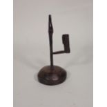 An 18th Century iron Rushlight Holder on domed wooden base, 9in H