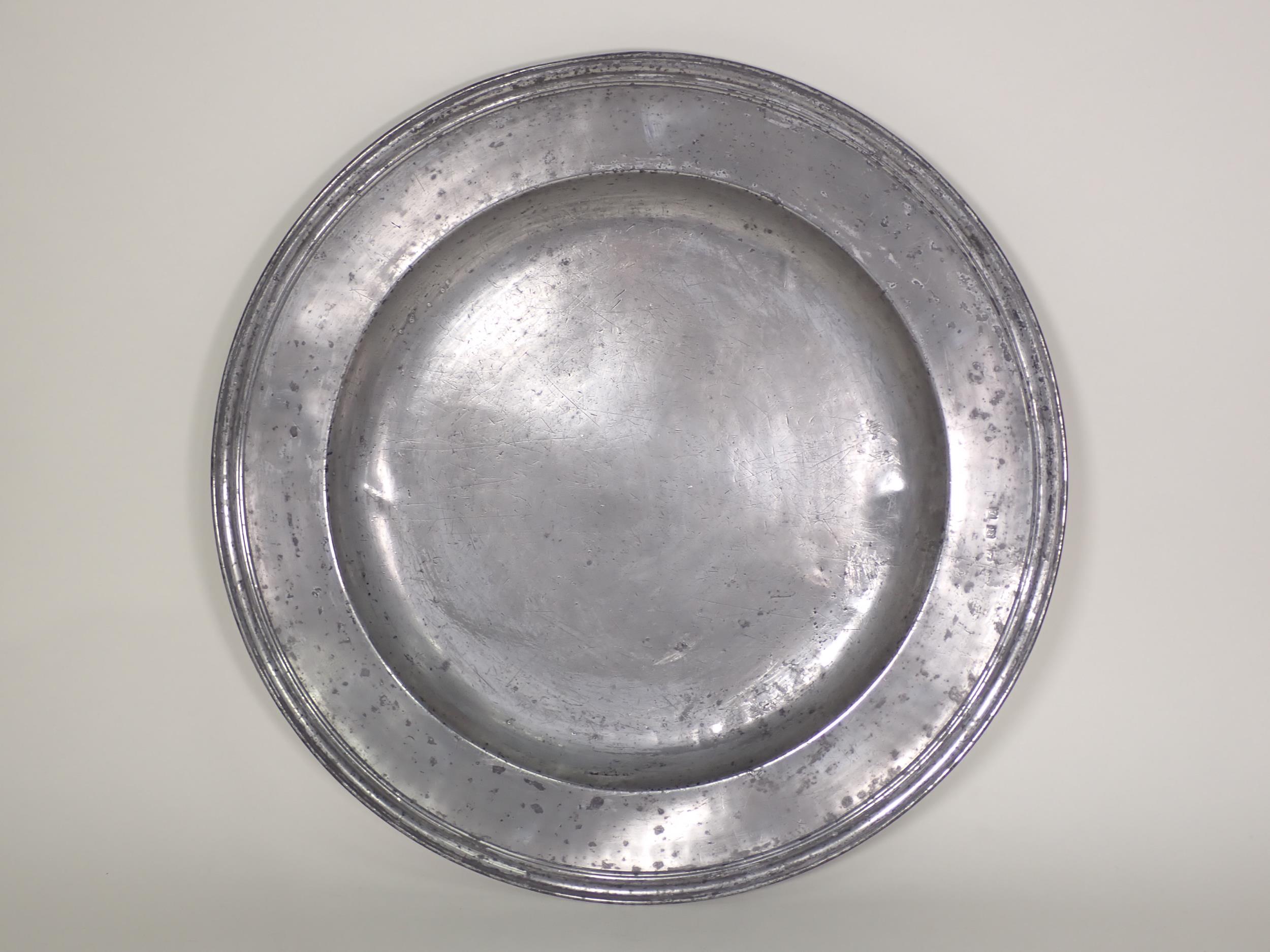 A c.1700 Pewter Charger with touchmarks for John Baskerville, with reeded edge and stamped