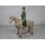 A green glazed Figure on horseback, possibly late Ming dynasty, 12in H, and two similar figures,