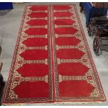 A pair of long red ground Runners with design of repeating floral pillars, 17ft 8in L x 4ft1in W