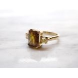 A Zircon and Diamond three stone Ring corner claw-set yellow/brown zircon between two old-cut