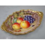 A Royal Worcester oval shaped two handled Dish with shell moulding, painted still life of fruit,