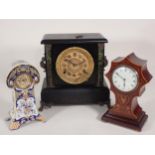 A Victorian black lacquered Mantel Clock with marble effect columns on paw feet 1ft H x 10in W, an