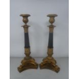 A pair of French Empire Candlesticks in ormolu and bronze, with classical mouldings, plain bronze