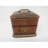 A set of four square glass Perfume Bottles and Stoppers in leather case having gilt tooled